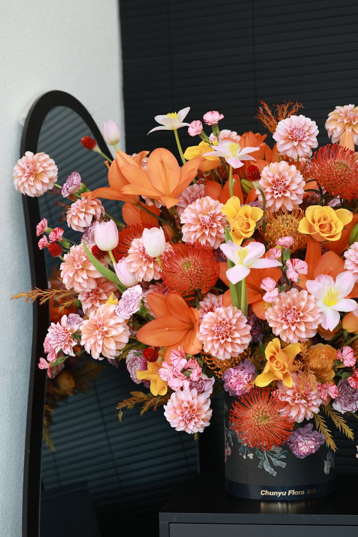 Colorful floral bouquet with mirror reflection, showcasing orange blooms in a stylish arrangement.